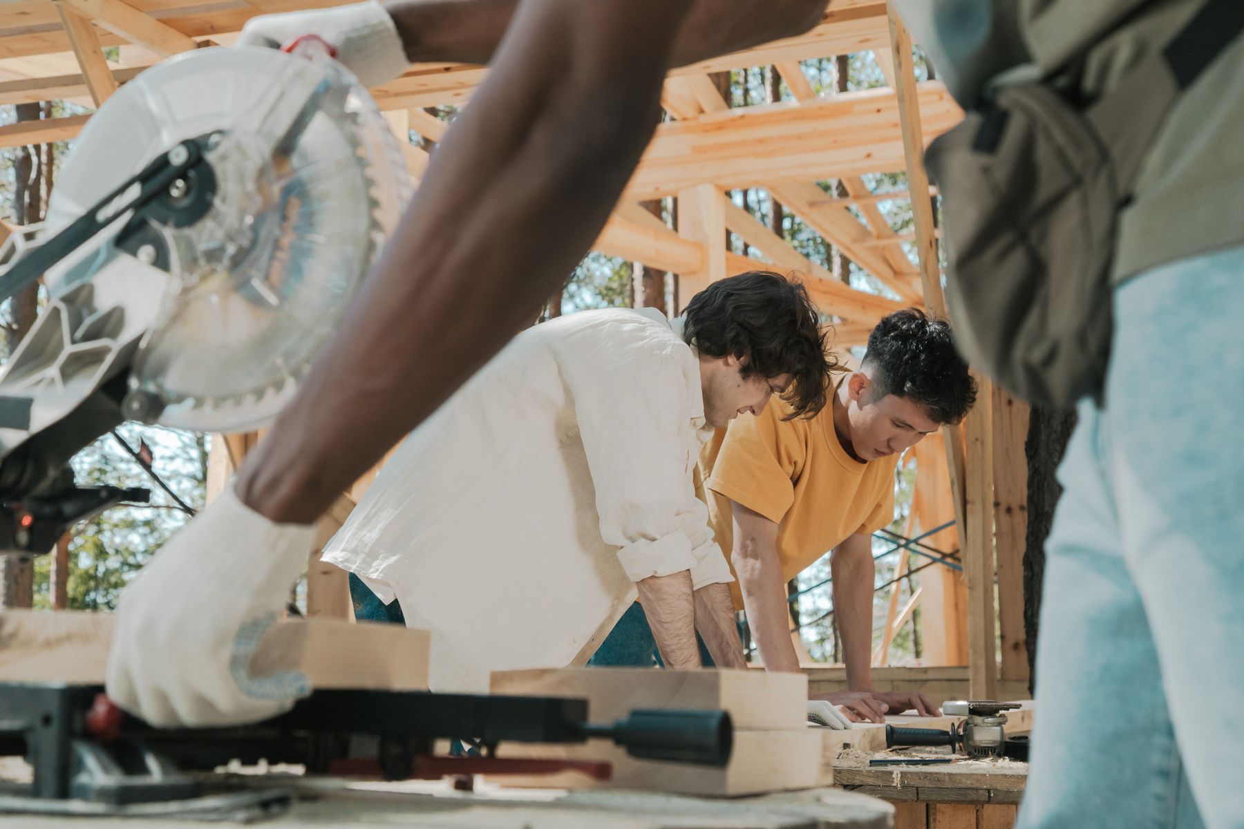 Builders reviewing work beside a circular saw on a framing site