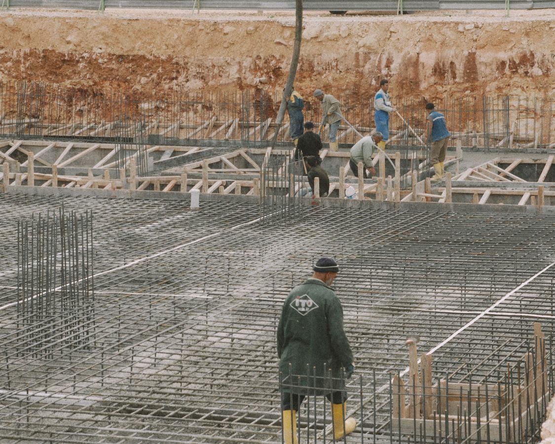 Construction crew preparing reinforced concrete foundations on an active building site