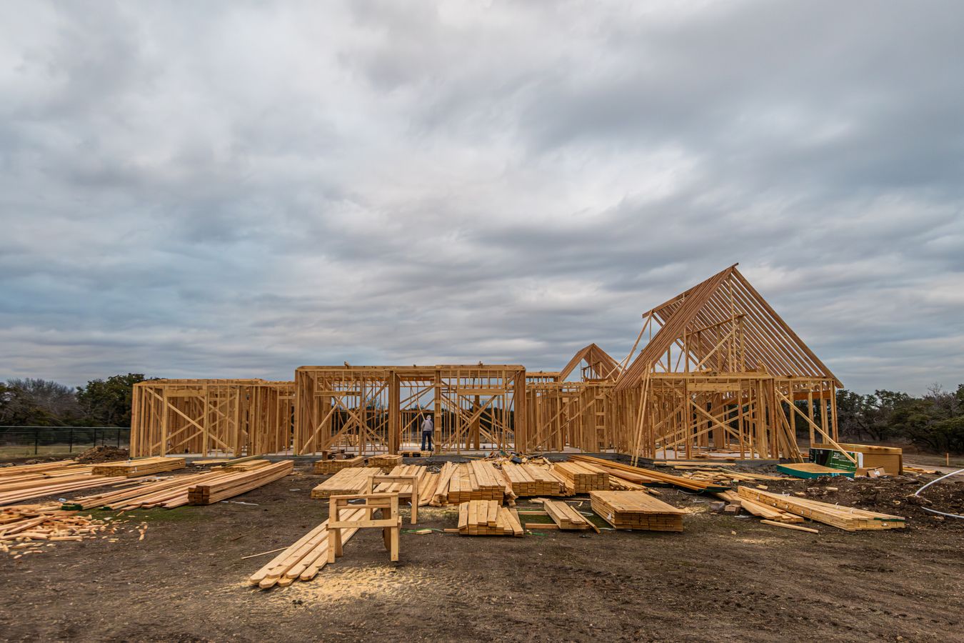 Wide view of a timber-framed home under construction