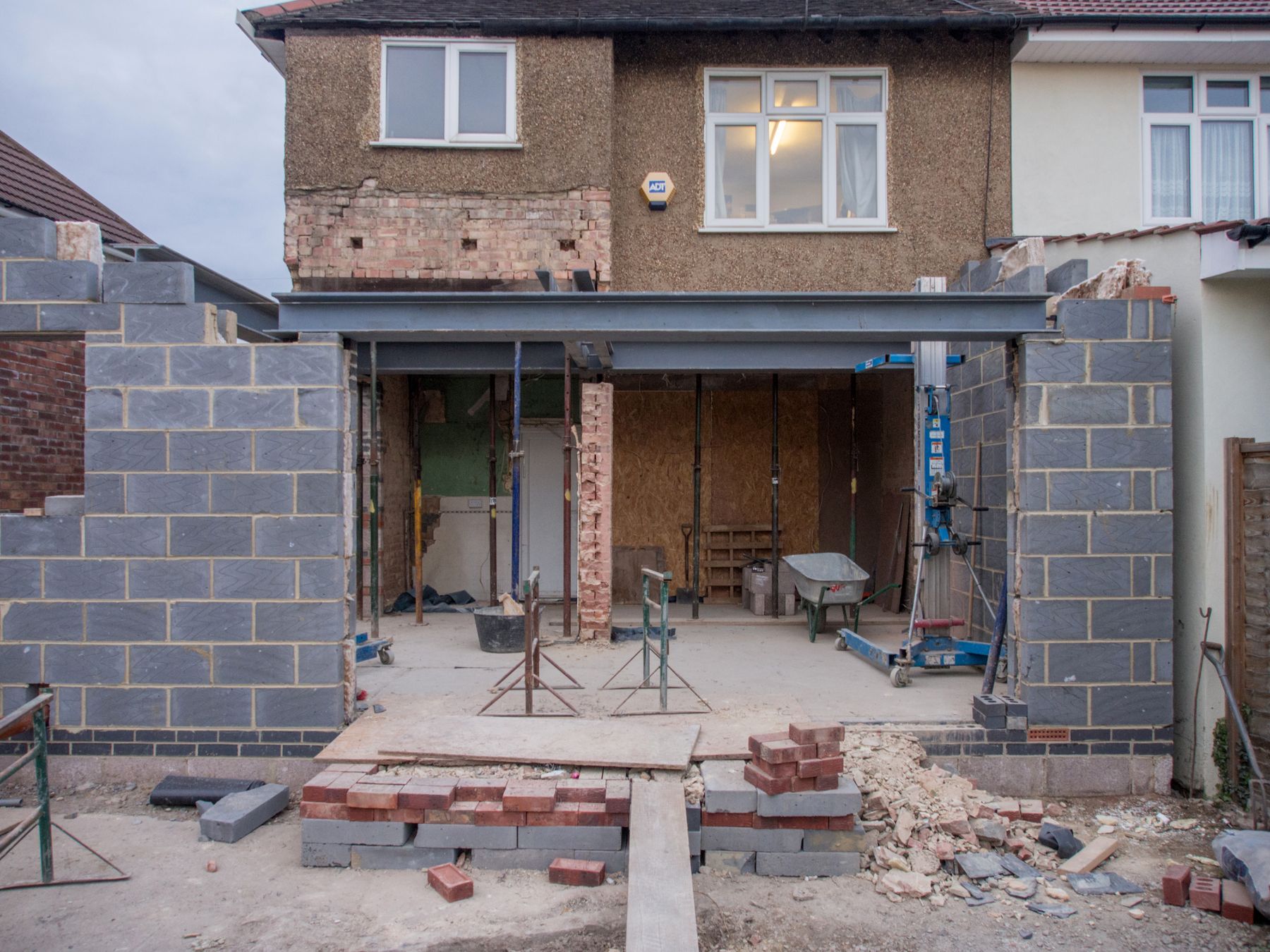 Residential masonry addition under construction at the rear of a home