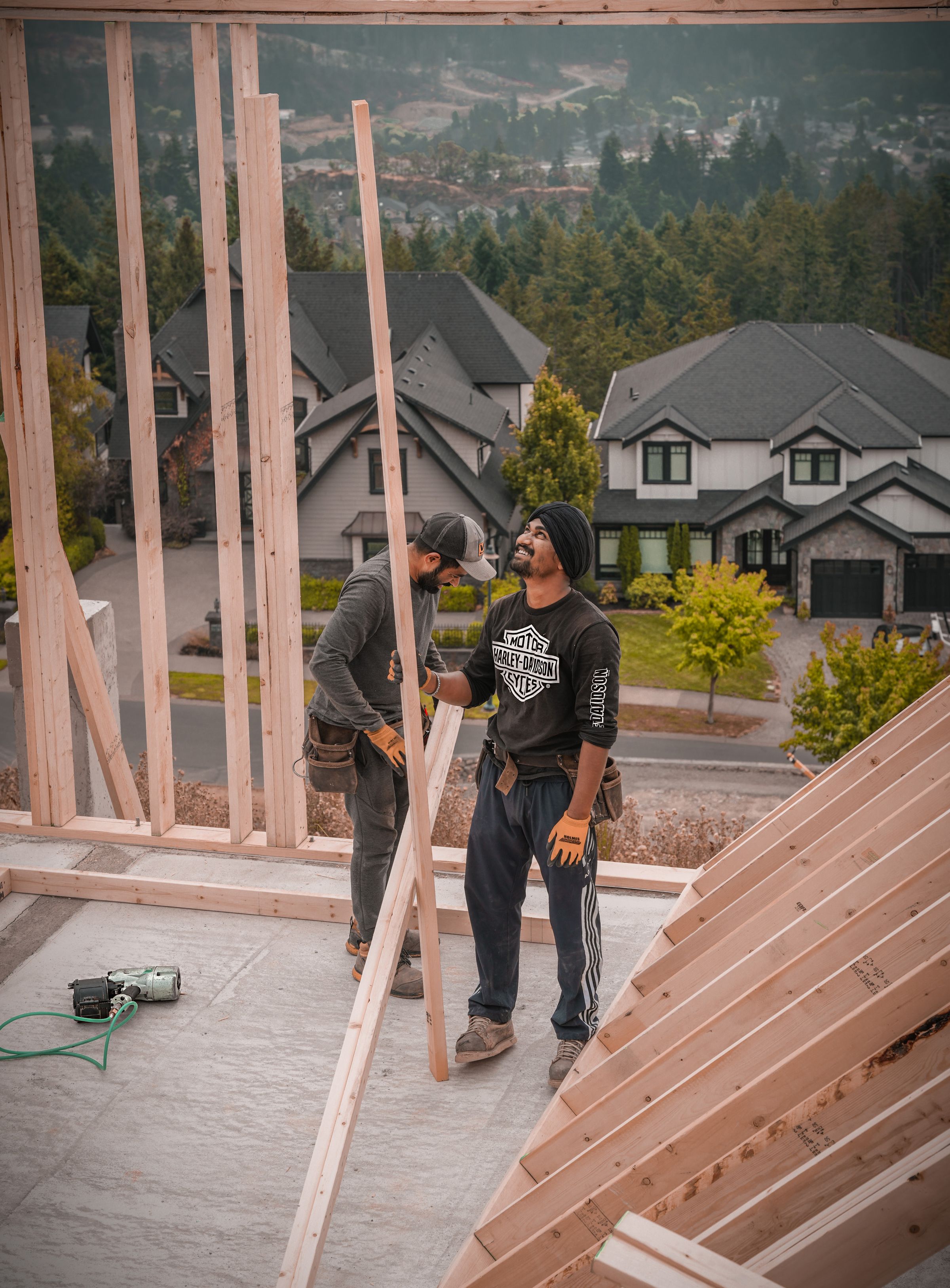 Builders installing wall framing on a residential construction site